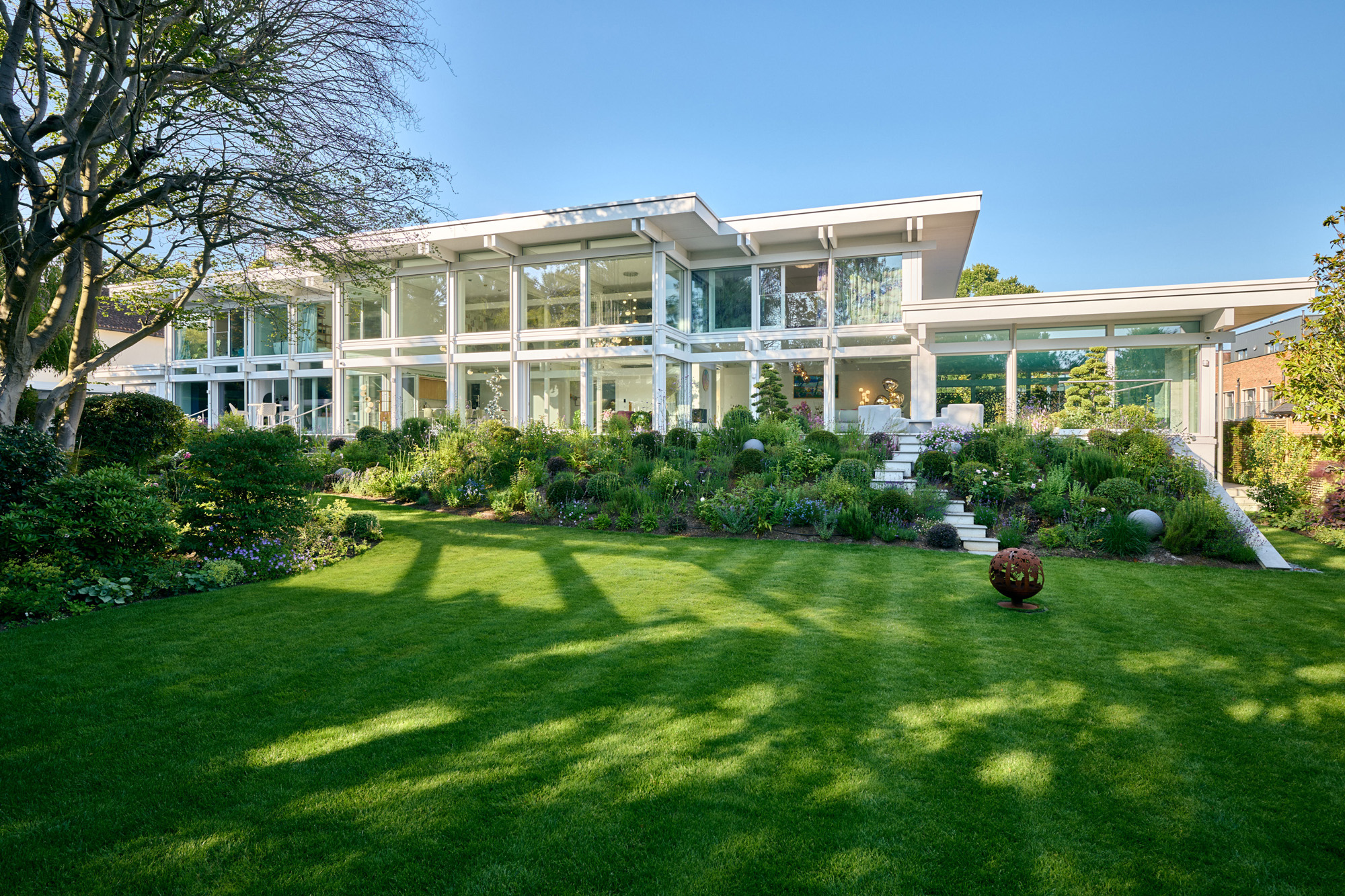 HUF Architektenhaus mit Flachdach und Garten Moderne weiße Villa mit Glasfront und grünem Garten