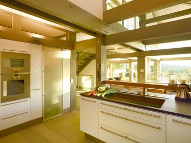 Moderne Küche in einem HUF HAUS Architektenhaus Luxuriöse und helle Küchendesign mit Glasflächen und stilvoller Einrichtung