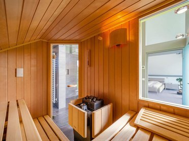 Geräumige Sauna mit Blick auf den Wohnbereich und stilvollem Design