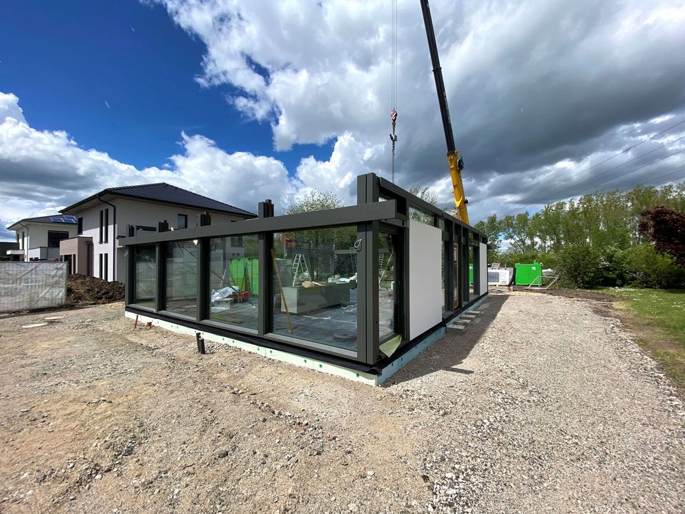 Construction site of a modern glass structure with a crane