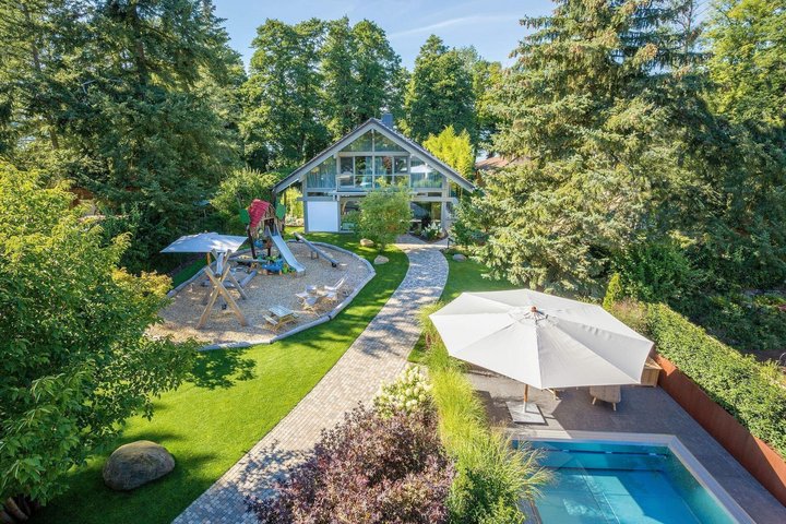 HUF Haus mit Anbau, Poolhaus und Garagenanlage Ansicht von HUF Haus, Poolhaus und Spielplatz im Garten