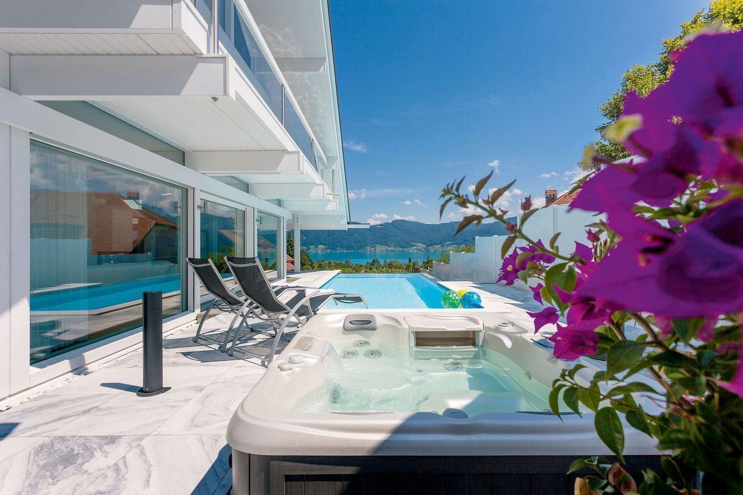 Terrassengarten mit Pool und Blick auf sanfte Hügel und See
