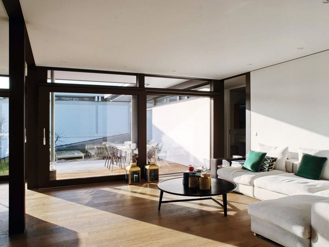 Helles Wohnzimmer in modernem Architektenbungalow Lichtdurchflutetes Wohnzimmer mit minimalistischer Einrichtung