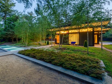 Modernes HUF Bungalow mit Pool und Garten Traumhaftes modernes Bungalow umgeben von Bäumen und einem Pool