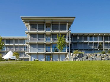 Moderne Architektur des Bürogebäudes HUF mit grünem Rasen