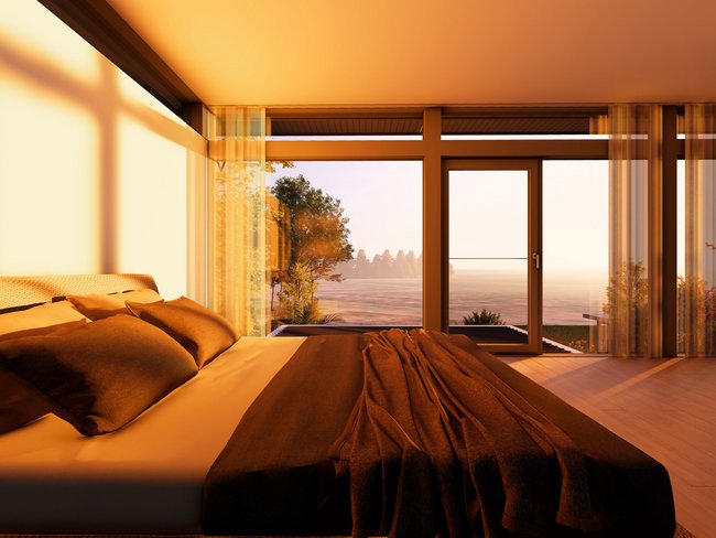 Modernes Schlafzimmer in einem Architektenhaus Ein luxuriöses Schlafzimmer mit Aussicht auf die Natur und viel Licht