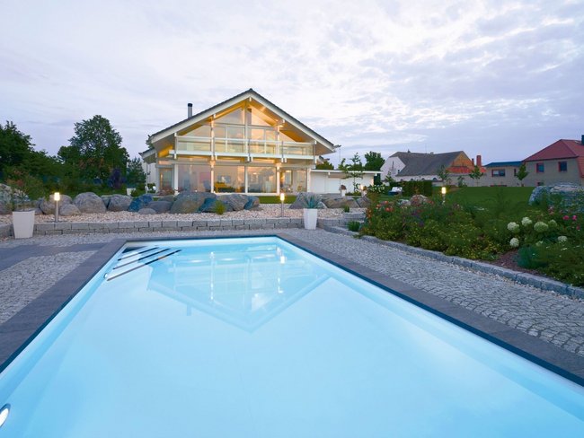 Fachwerkhaus HUF HAUS ART 4 mit Pool Moderne Architektur eines HUF Hauses mit Pool und Gartenlandschaft