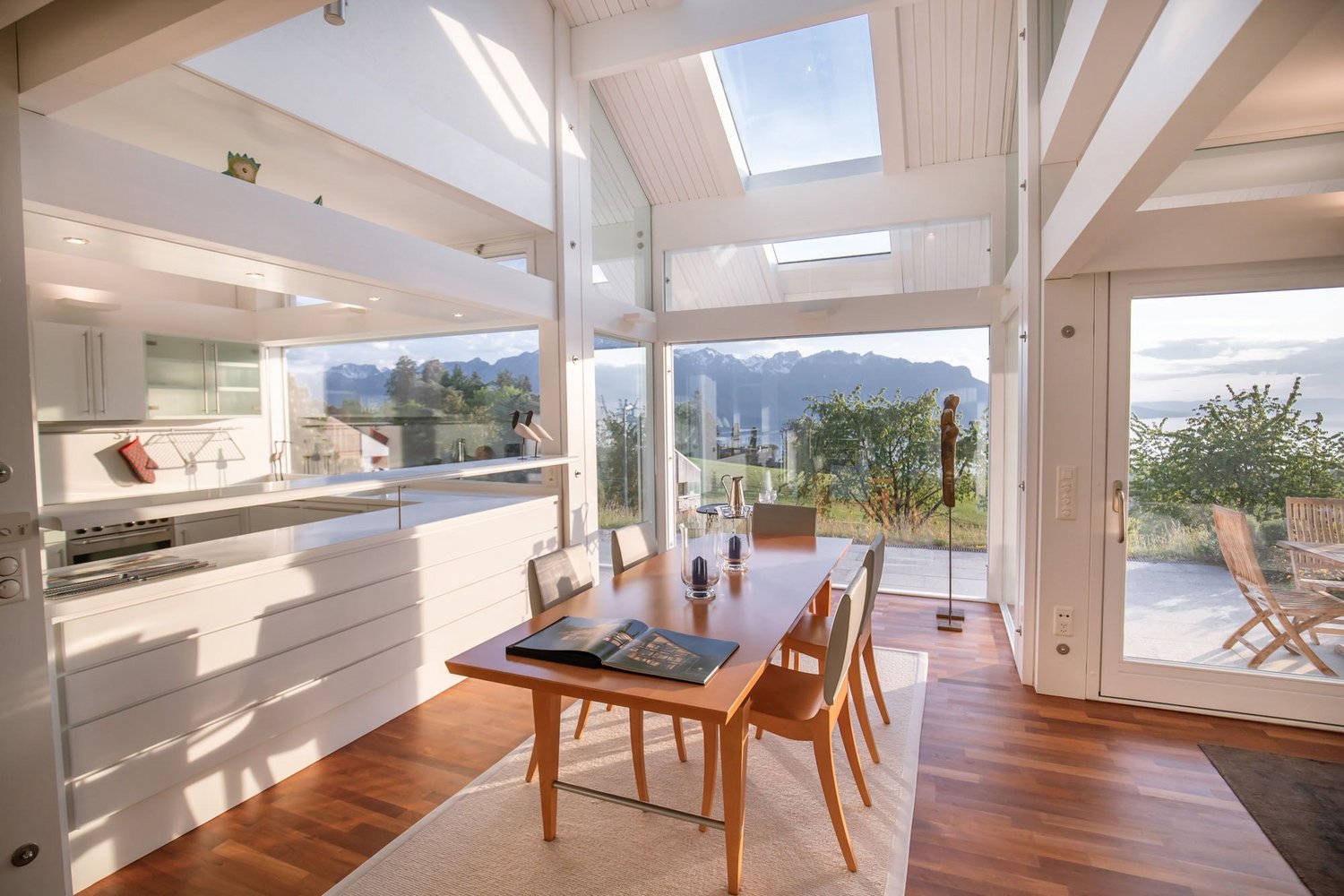 Helles, modernes Interieur mit großen Fenstern und Essbereich.