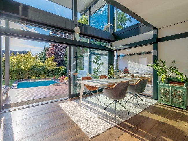Modernes Designhaus mit Flachdach und Gartenblick Helles modernes Wohnambiente mit Blick auf den Garten und Pool