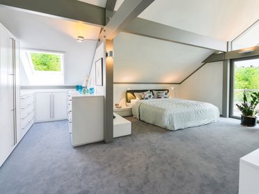 Helles, modernes Schlafzimmer mit Pflanzen und minimalistischer Einrichtung