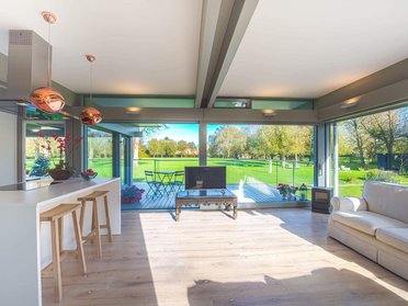 Stilvoller HUF Anbau mit harmonischem Wohnraum Moderner Wohnraum im HUF Anbau mit Blick ins Grüne