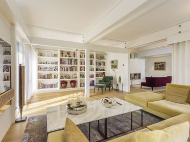 Stilvolles Wohnzimmer einer Fachwerk-Villa mit Bücherregal und Sofas