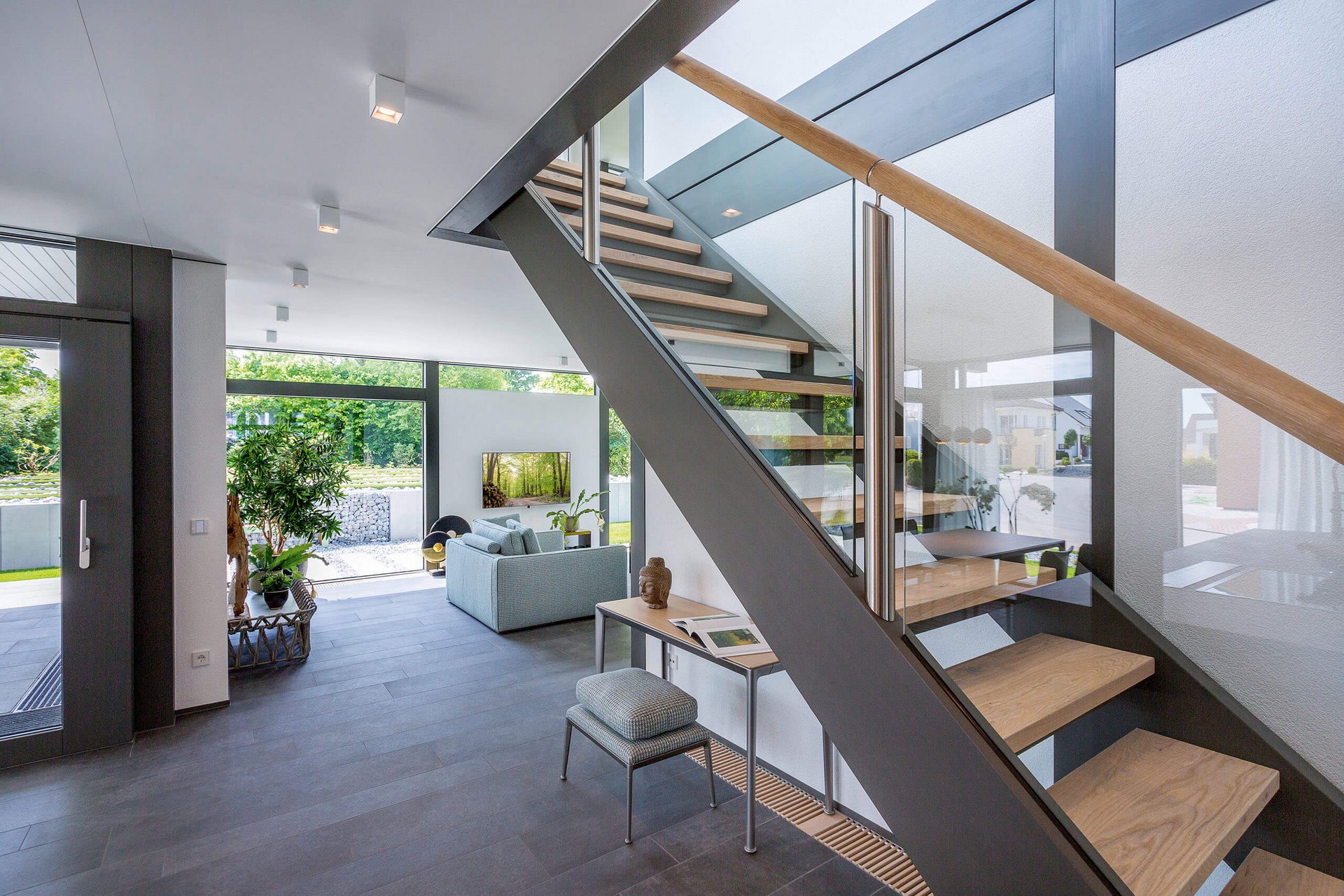 Lichtdurchfluteter Wohnraum mit Treppe und gemütlicher Sitzecke