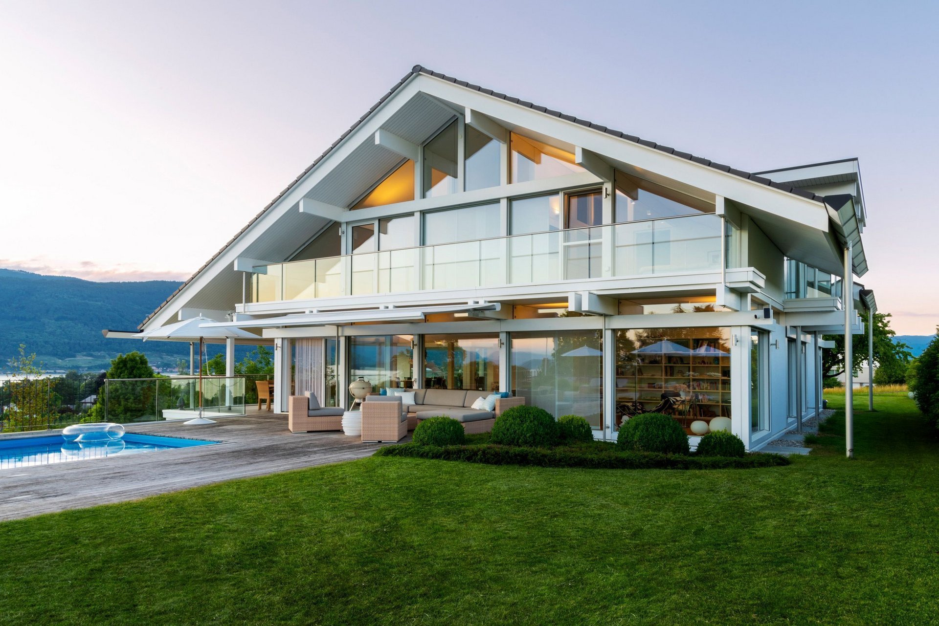 Elegantes Designhaus mit großen Fenstern und einem Pool im Garten