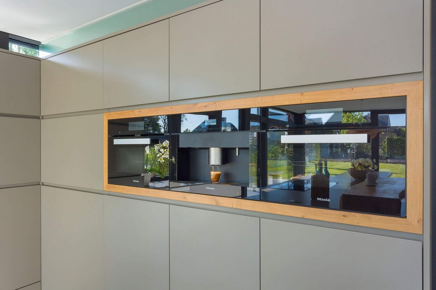 Elegante Küchenfront mit Holzrahmen und modernen Geräten