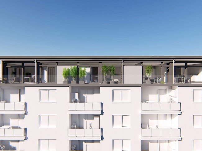Moderne Architektur mit Aufstockung und Terrassen auf einem Wohngebäude