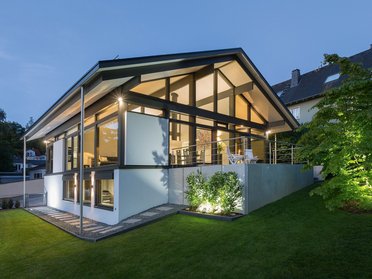 Architektenbungalow mit großzügiger Glasfront und Gartenbeleuchtung