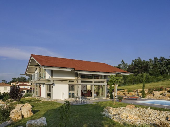 Ferienhaus mit rotem Dach und modernen Elementen in der Natur