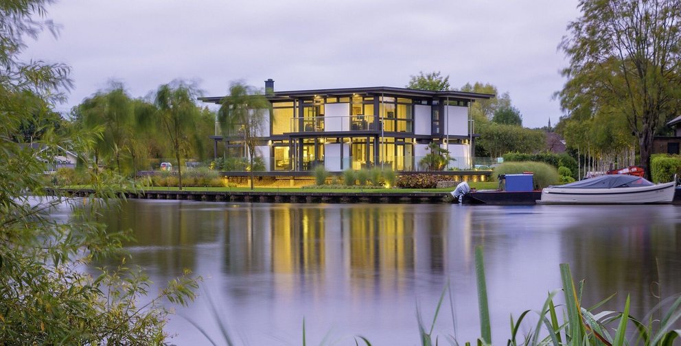 Contemporary architecture reflecting on a calm water surface