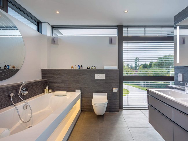 Helles und stilvolles Badezimmer mit Badewanne und Fenster