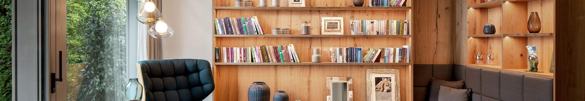 Modernes Wohnzimmer mit Holzmöbeln und Bücherregal Gemütliches Wohnzimmer mit Sitzbereich und modernen Elementen