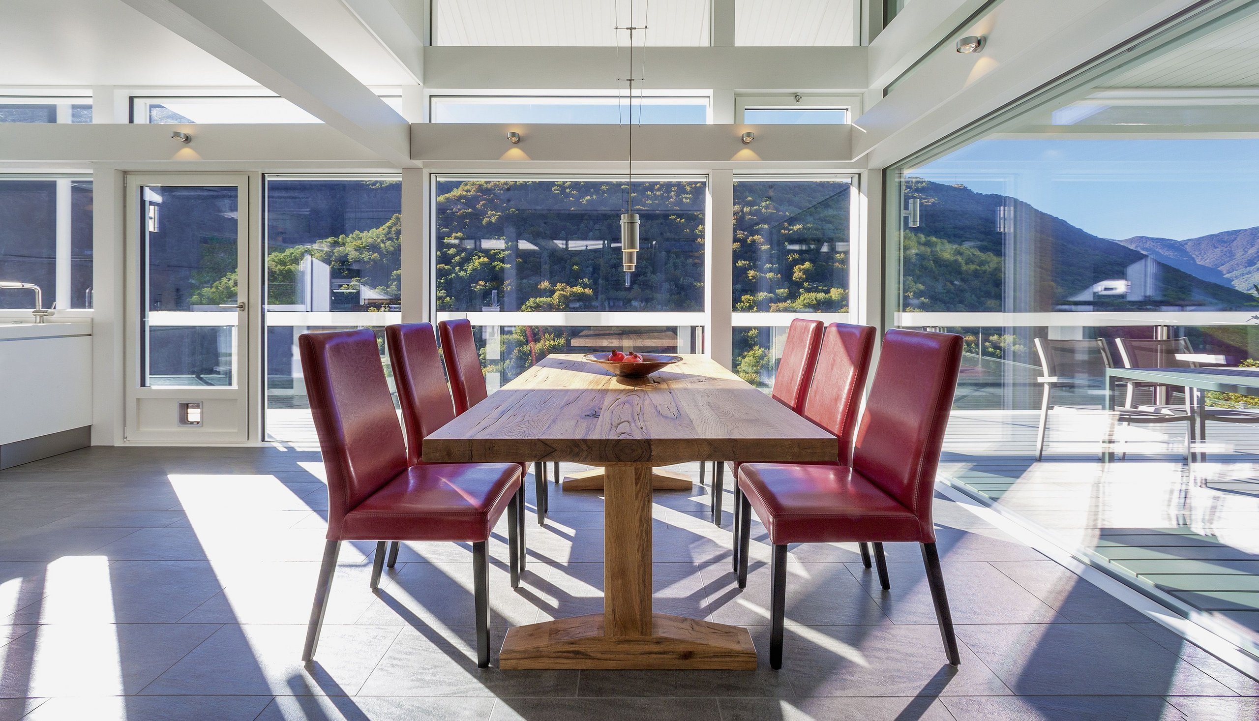 Bright dining area featuring red chairs and large windows